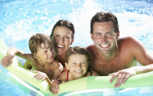 Happy Family Staying Cool In Pool