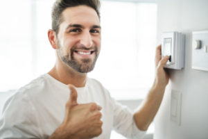Happy Man Sets Thermostat